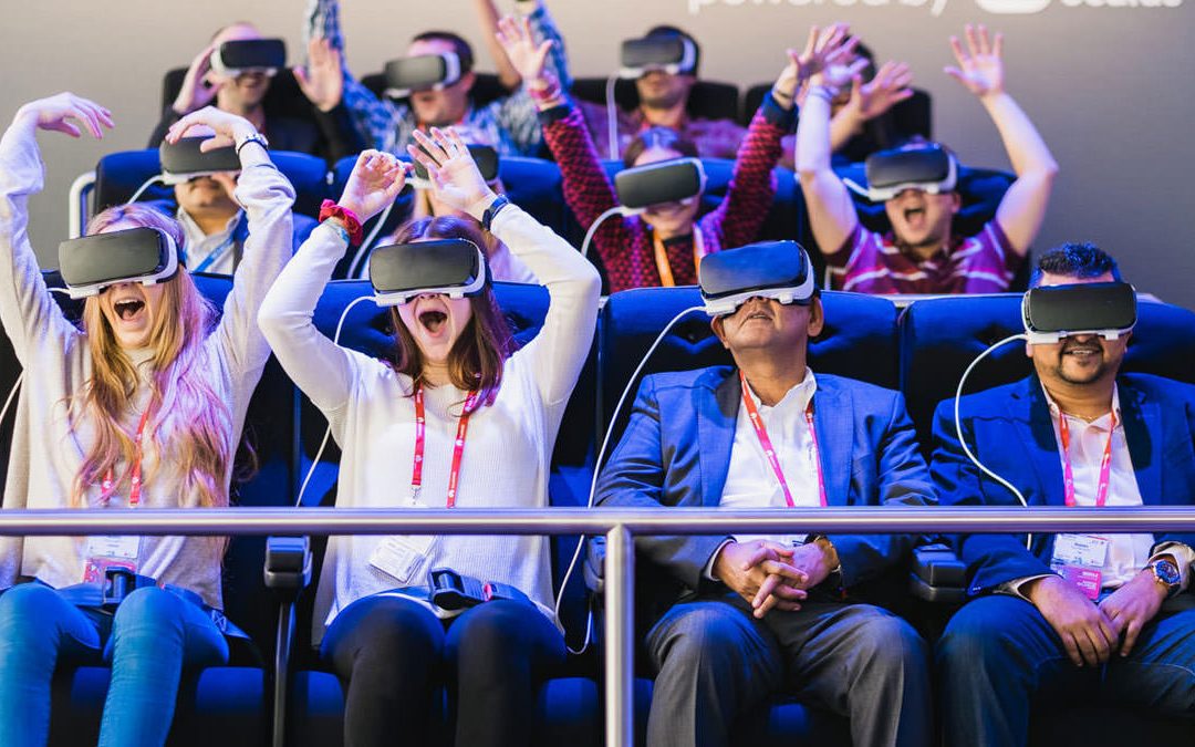 A photography of people on a virtual reality ride, smiling and laughing