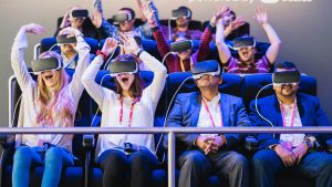A photography of people on a virtual reality ride, smiling and laughing
